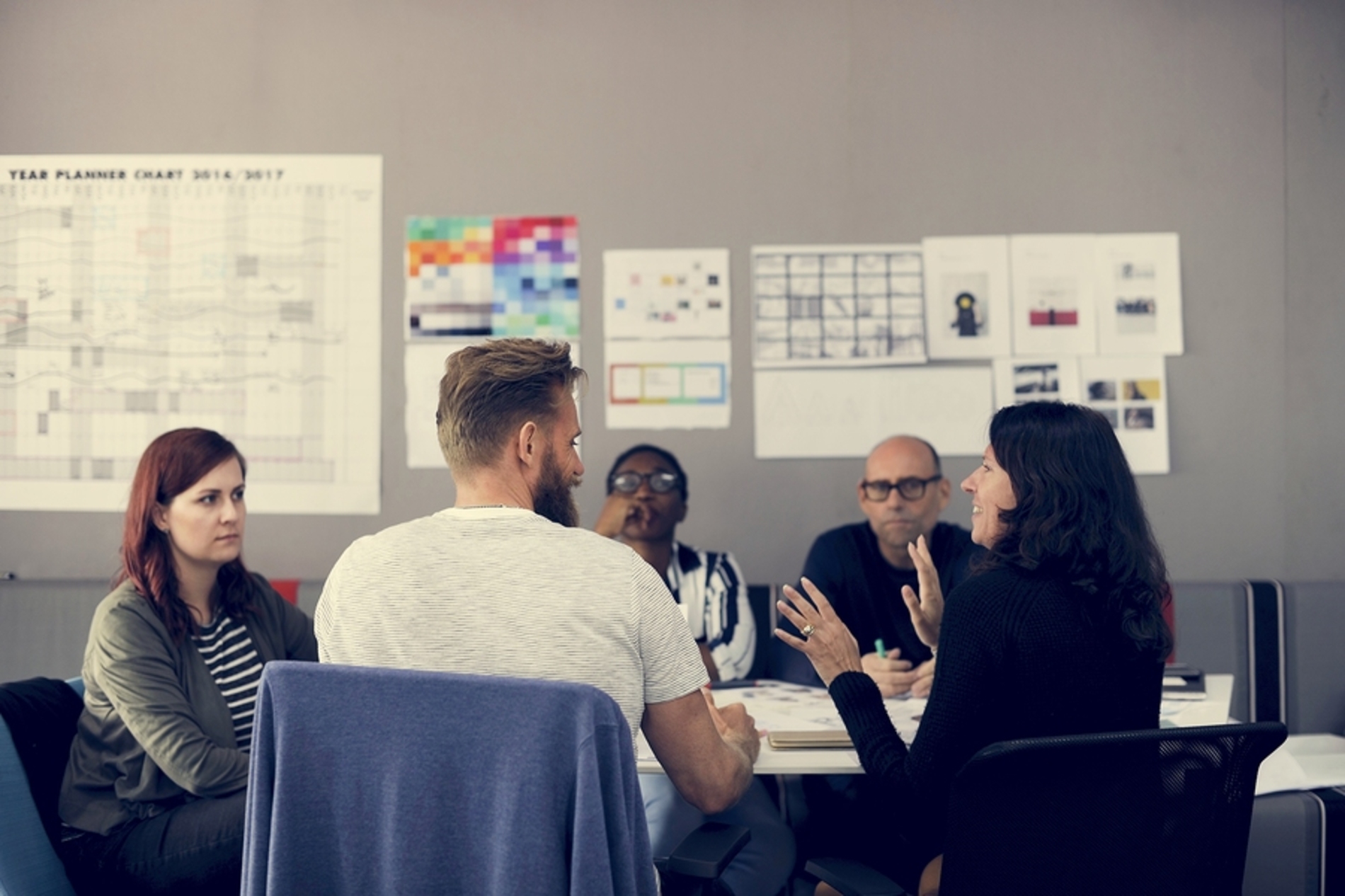 Group of colleagues discussing a project around a table.