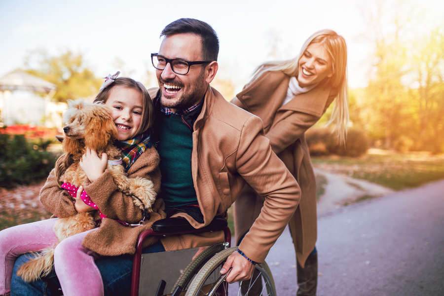 Smiling family outside.