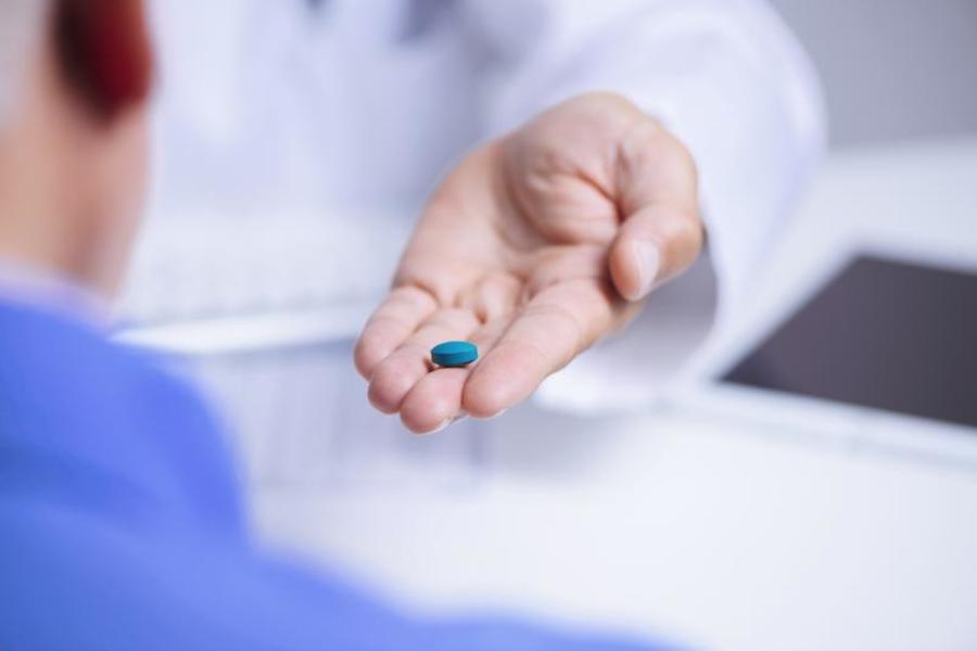 Holding a pill.