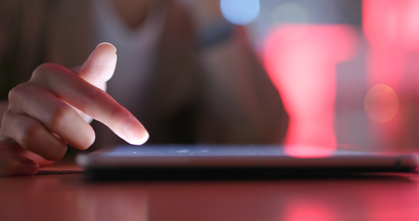 Typing on a tablet.