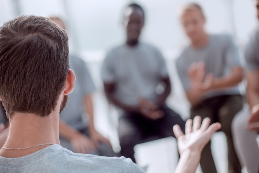 Group sitting around in a circle having a discussion.