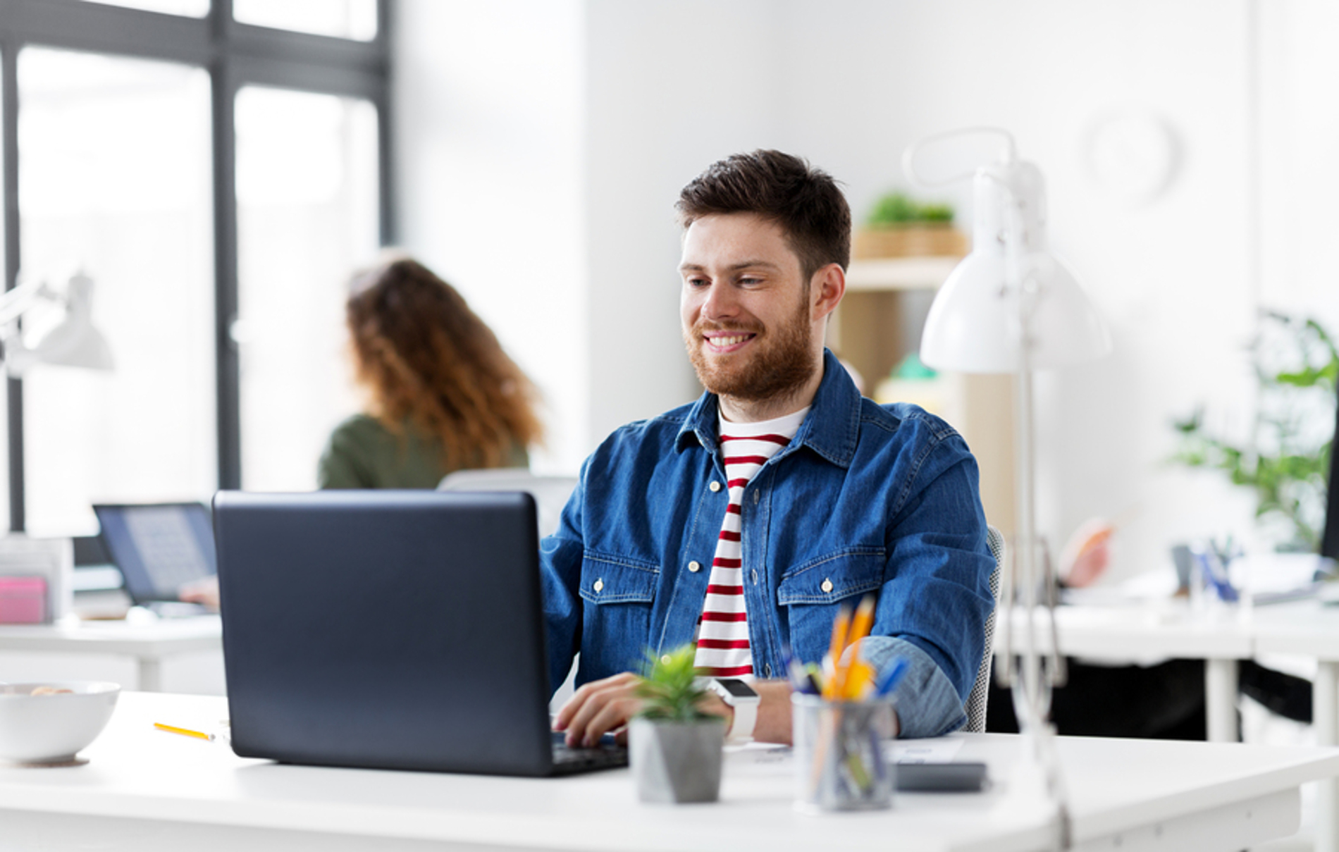 Man sitting at his desk working on a laptop. Man sitting at his desk working on a laptop.