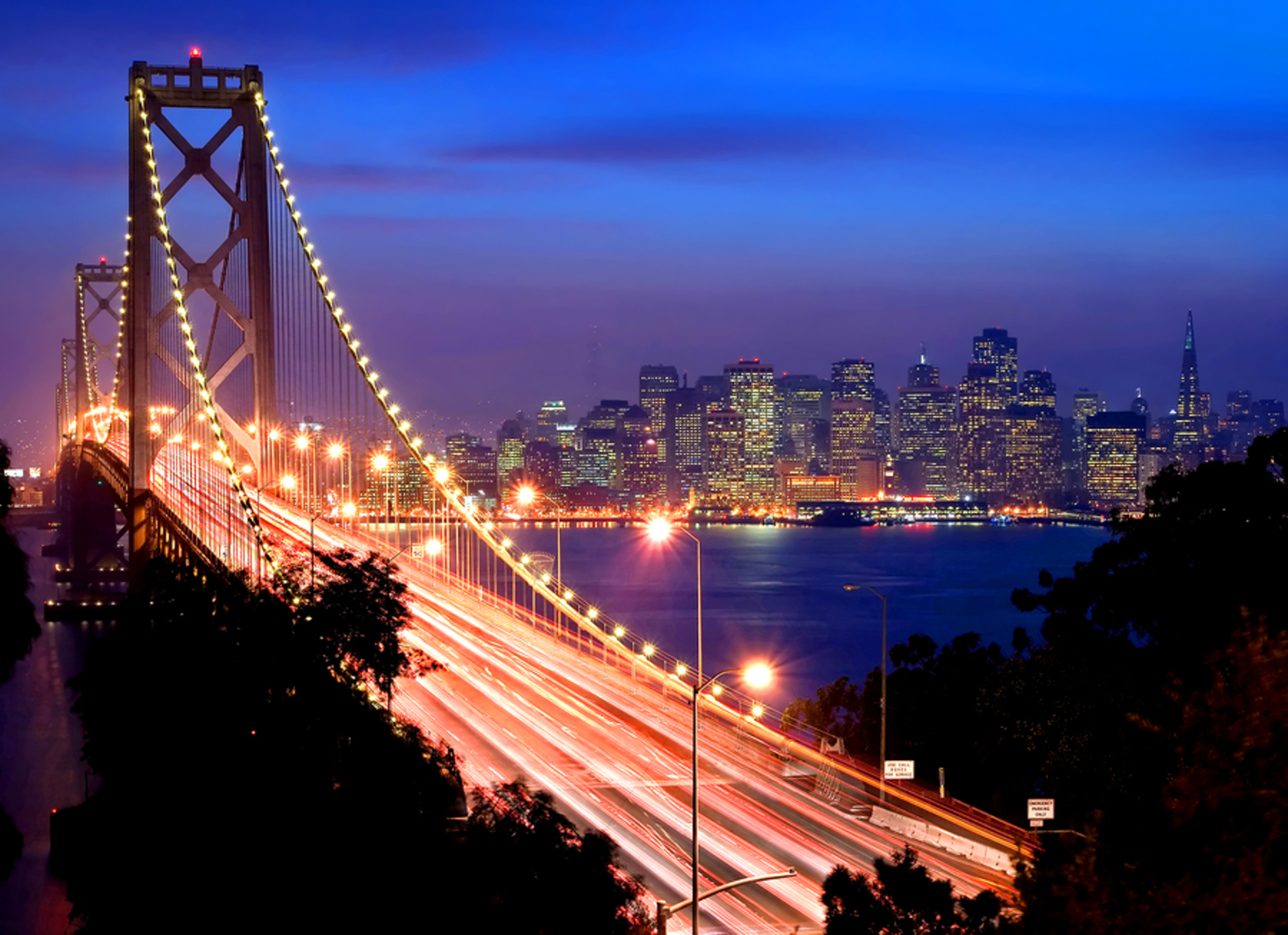 San Francisco bridge lit up at night.