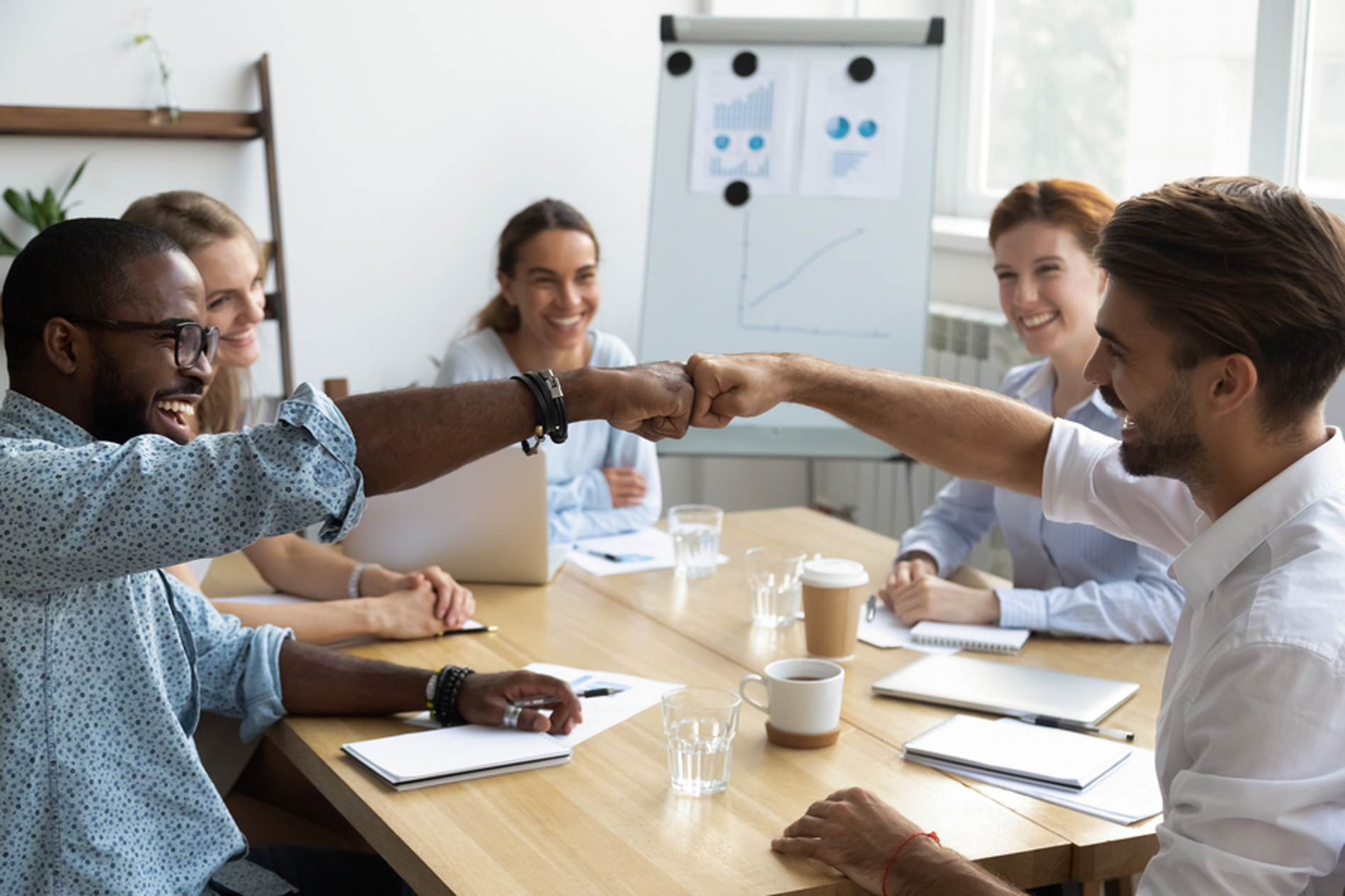 Group of people working around a conference table.