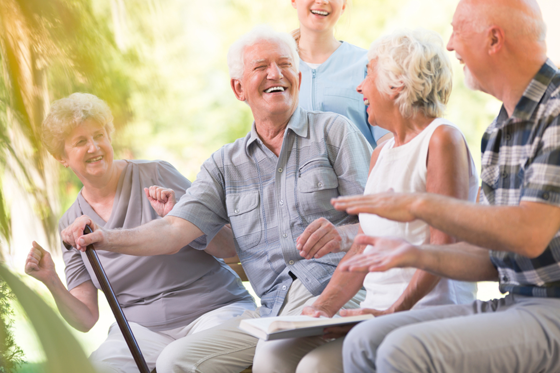 Group of elderly men and women smiling together.