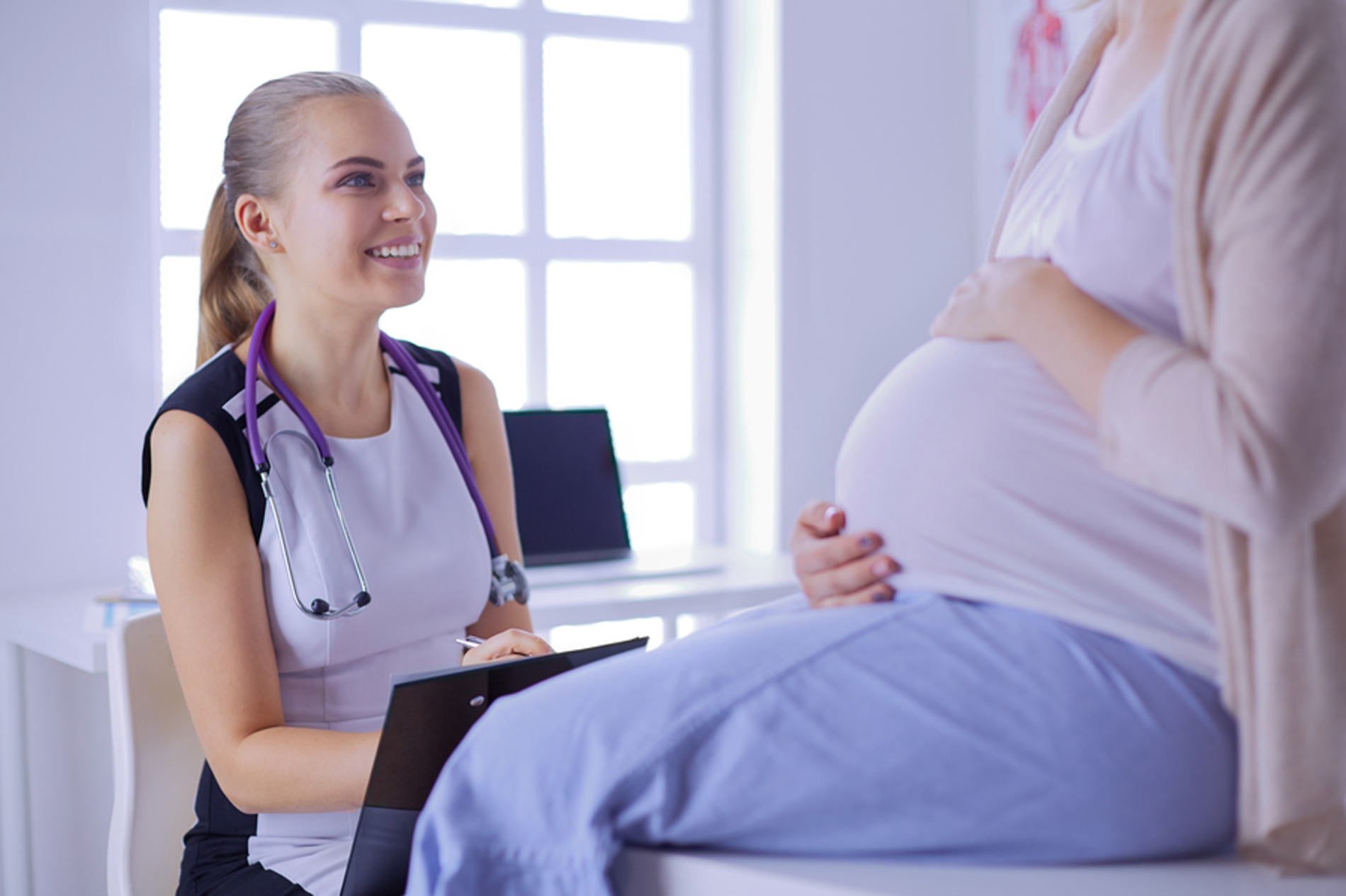 Medical doctor caring for a pregnant woman.