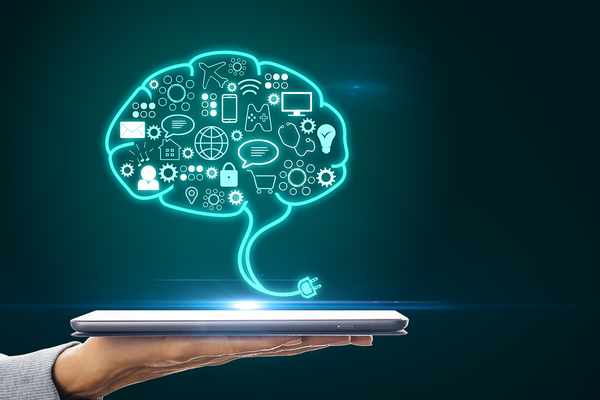 Illustration of a brain above a tablet.