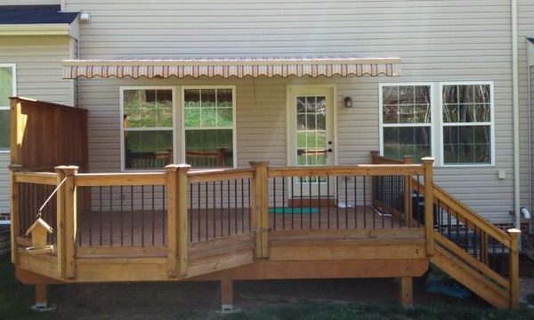 Backyard deck with an awning providing shade.