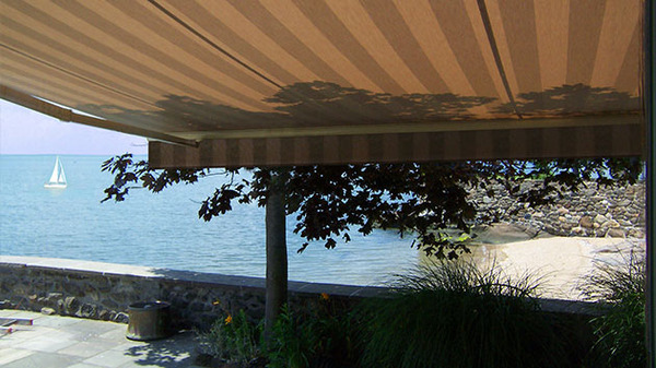 Outdoor awning providing a shaded place and view of the ocean.