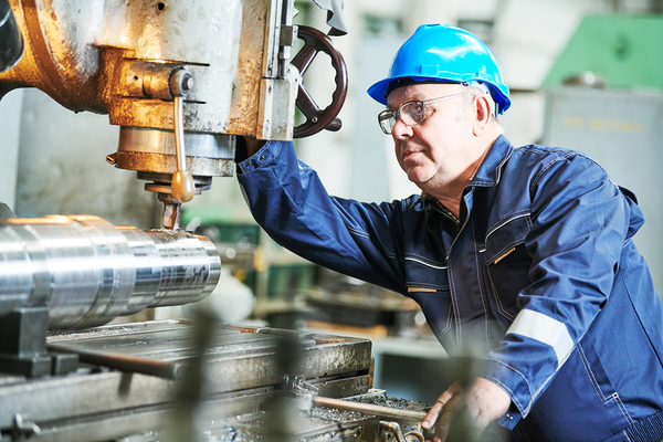 Factory worker operating a machine.