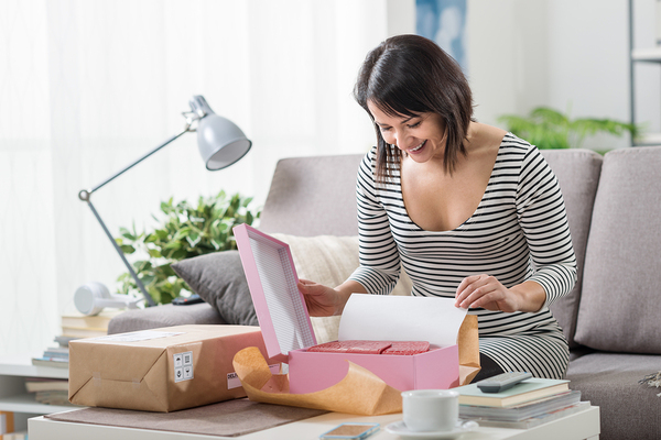 Woman unboxing parcel_600x