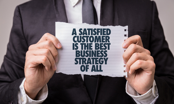 Holding a note "a satisfied customer is the best business strategy of all"