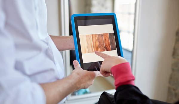 Person looking at hair colors on a tablet.