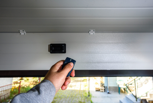 Person using a remote garage opener.