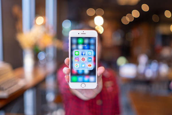 Cell phone with social apps on display.