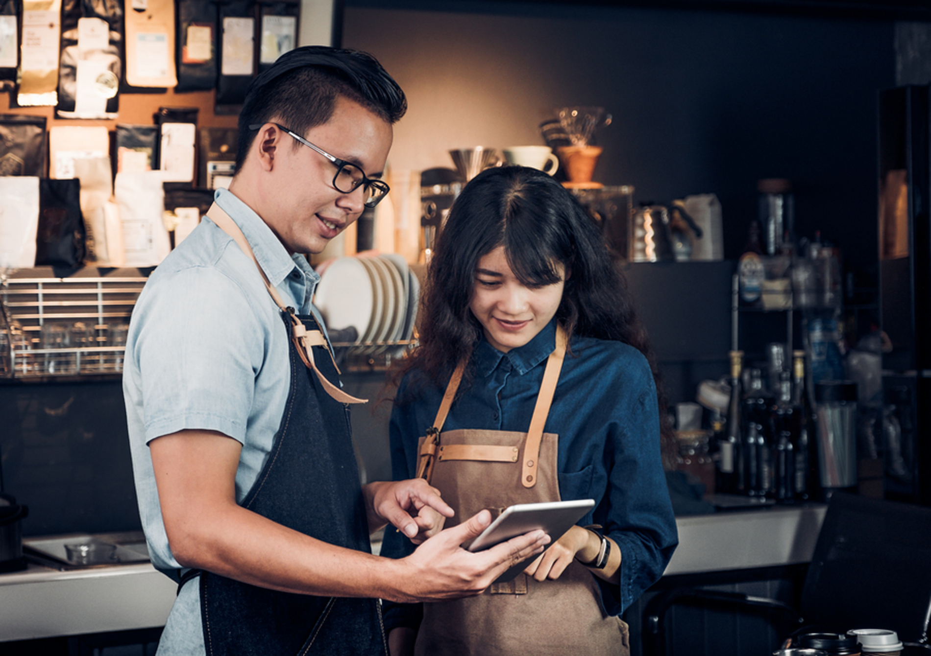 Business owners looking at reviews on a tablet.