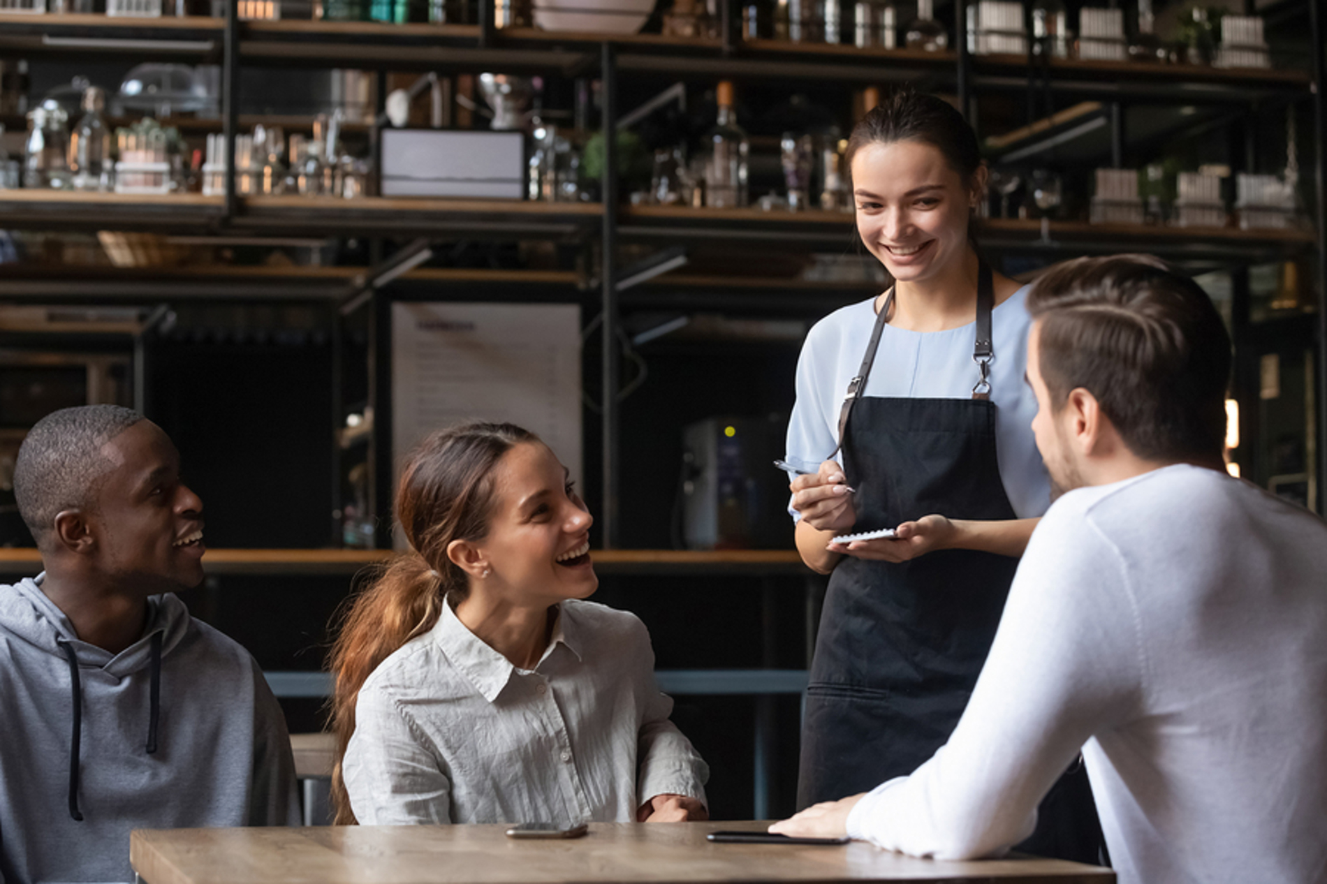 Group of people ordering food at a restaurant.