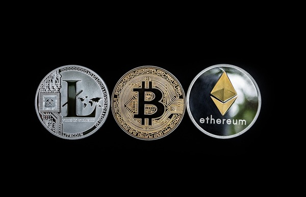 Silver and gold coins labeled Litecoin, Bitcoin and Ethereum.