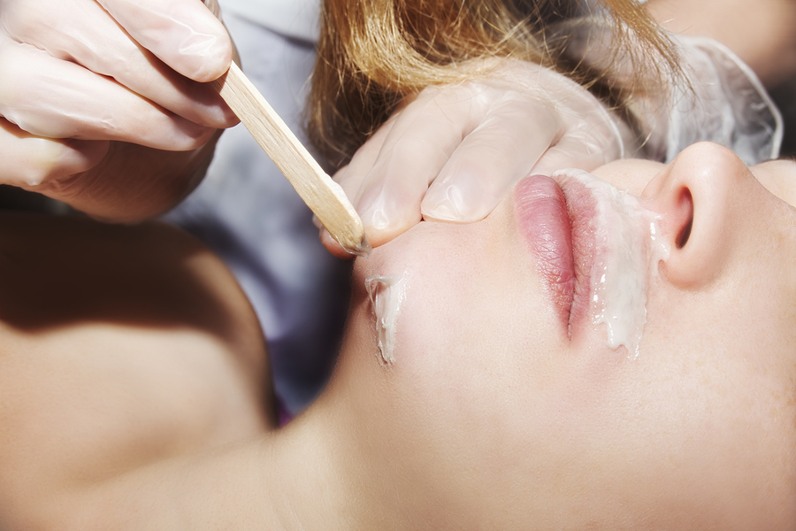 Woman having her upper lip and chin waxed.