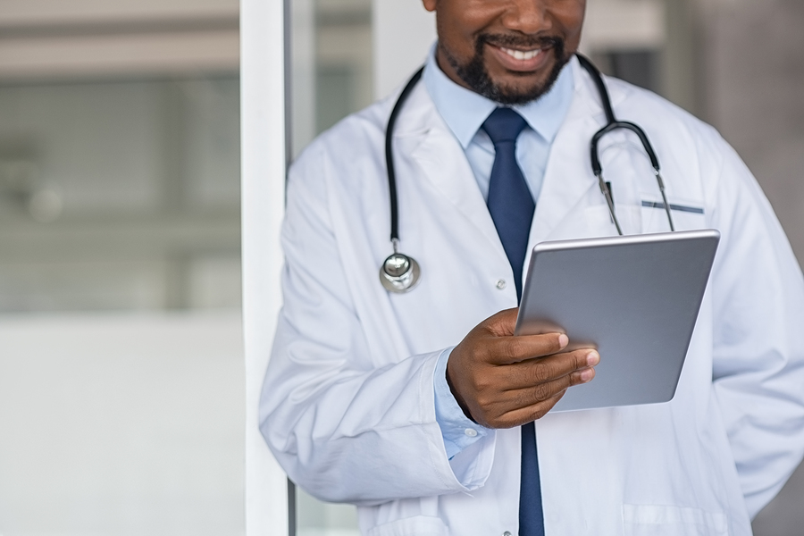 Medical doctor looking at his tablet.
