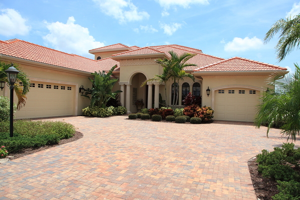 Tan colored home with tan gutters.