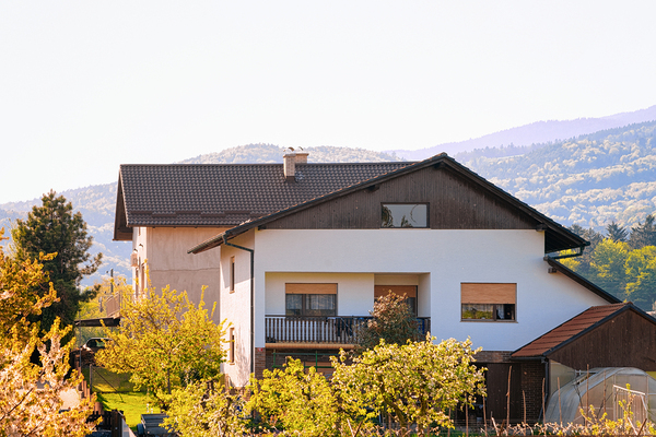 White home with brown gutters and trim.
