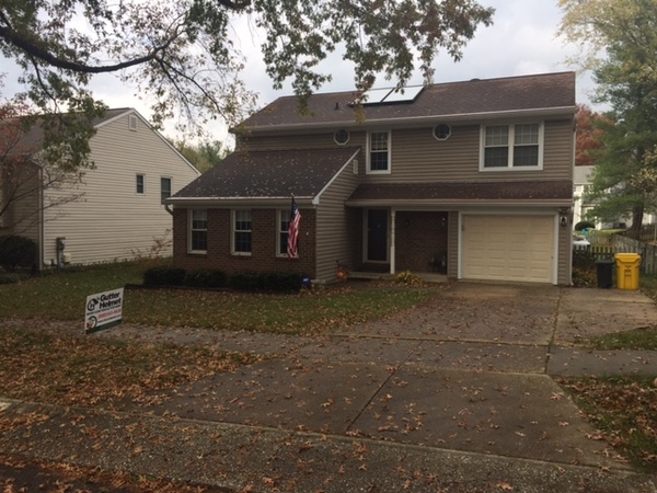 Single family home with one car garage and white trim.
