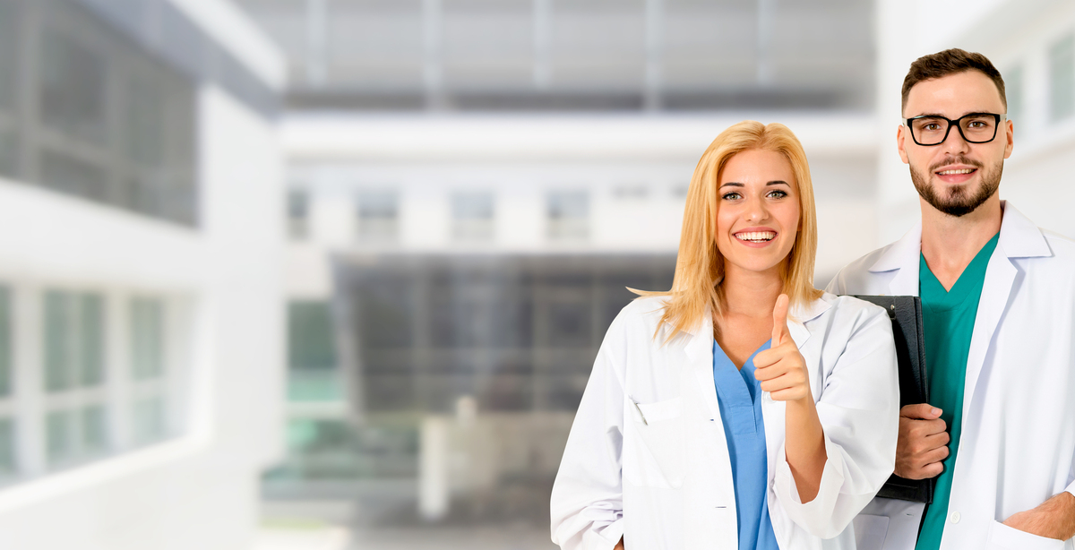 Two medical doctors giving thumbs up.
