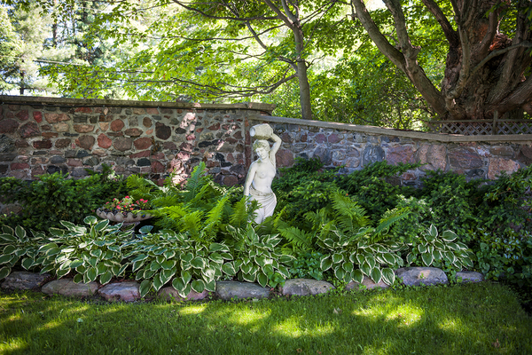 Statue of a woman in a garden.