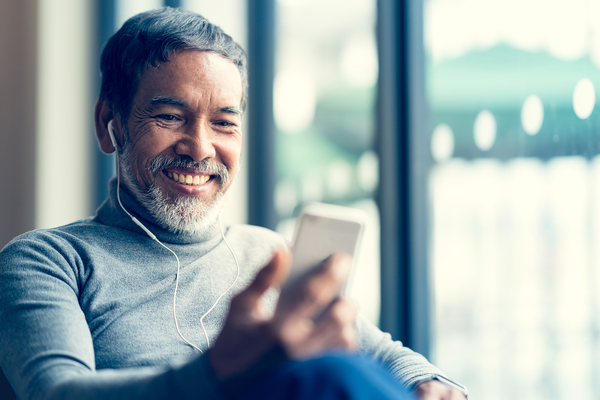 Smiling man looking at his phone.