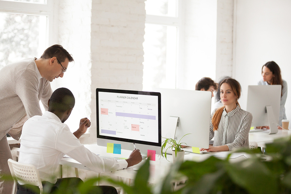Group of people working at desktop computers.