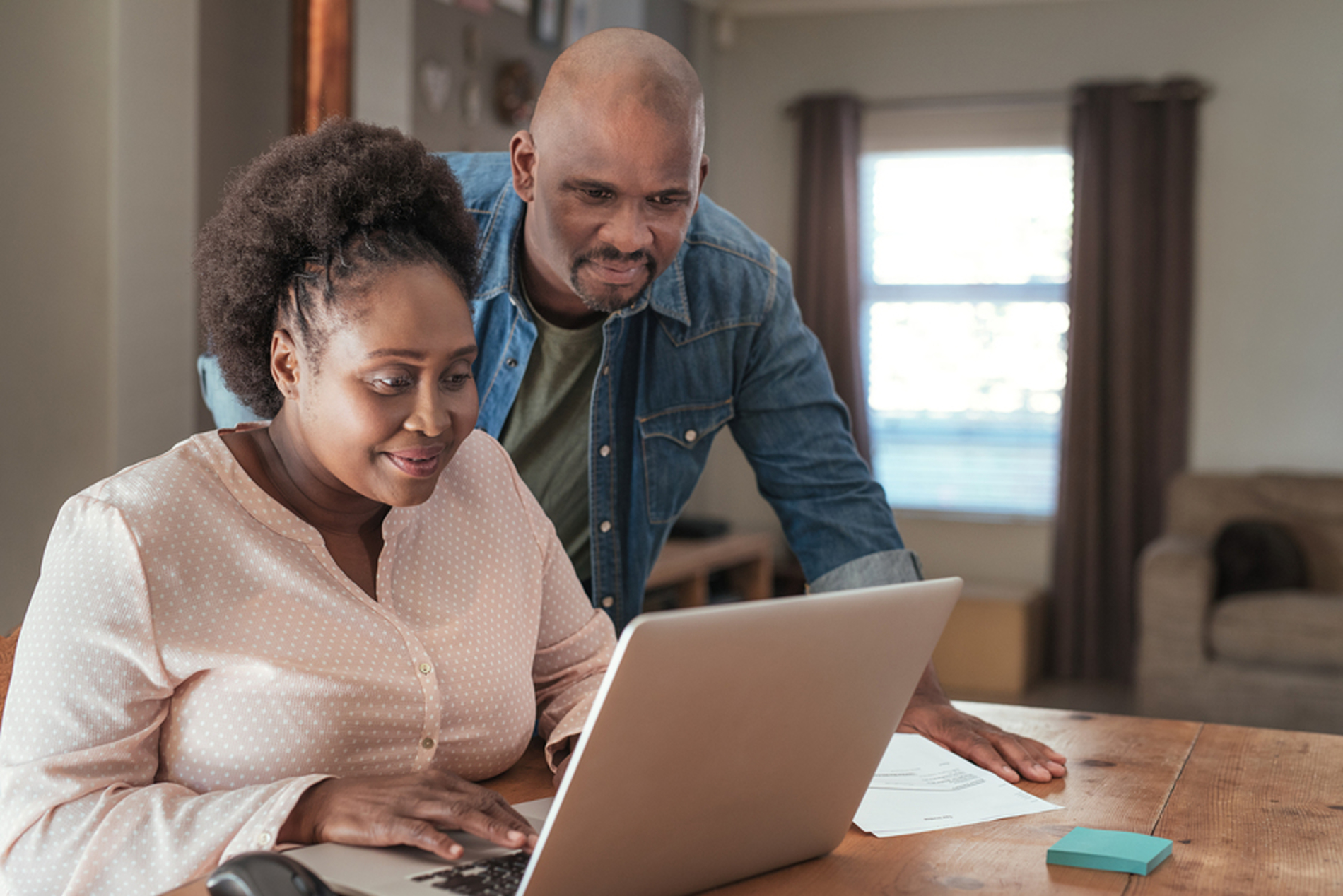 Older couple looking at a laptop together. Older couple looking at a laptop together.
