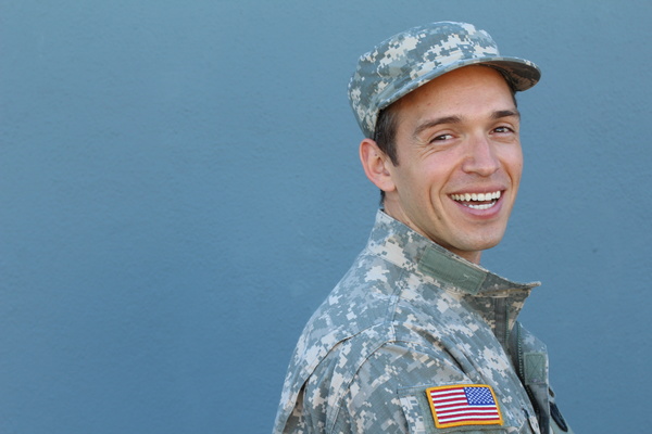 Smiling man wearing a military uniform.