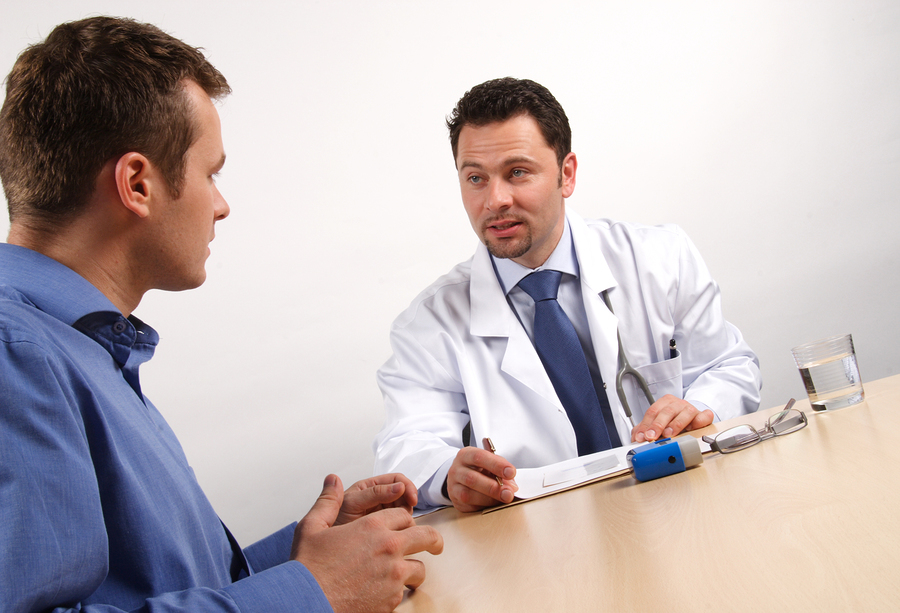 Medical doctor having a discussion with a male patient.