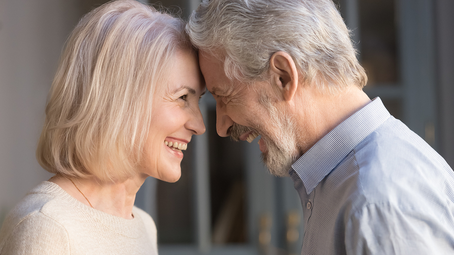 Smiling couple touching foreheads.