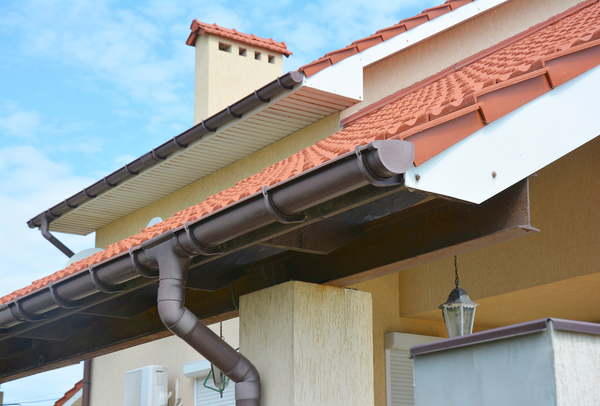 Roof with brown gutter and downspout.