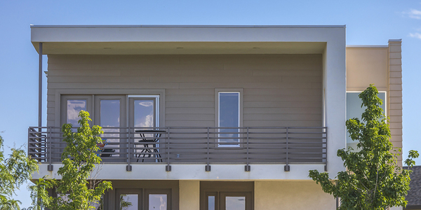 Flat roof home with balcony.