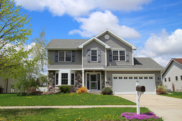 Gray house with white trim and one car garage.