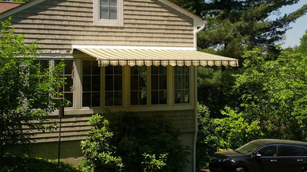 House with a yellow and green awning attached.