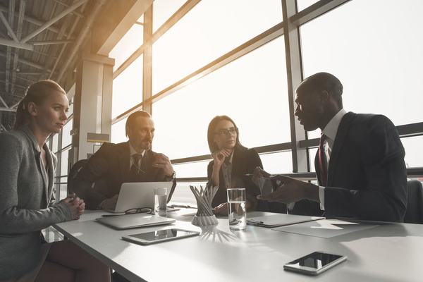 Group having a discussion around a table. enterprise data strategy