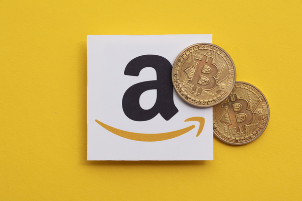 Amazon logo with gold bitcoins.