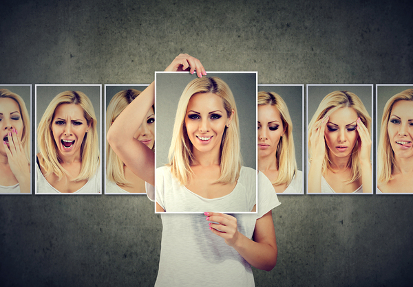 College student holding a photograph of herself.