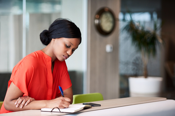 Woman writing in a notebook.