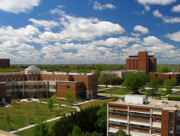 Campus with brick buildings and green lawn areas.