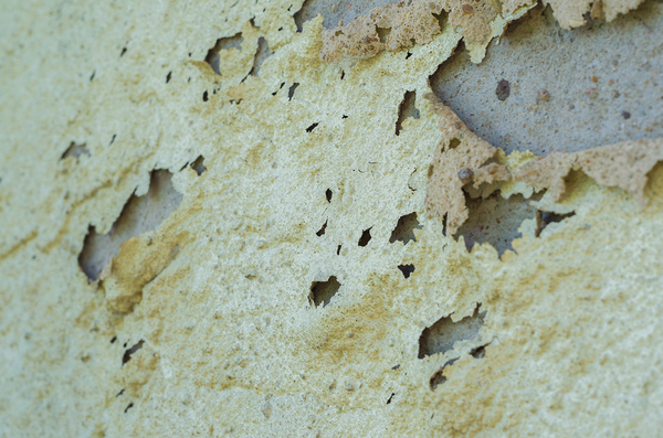 Close up of peeling vinyl siding.