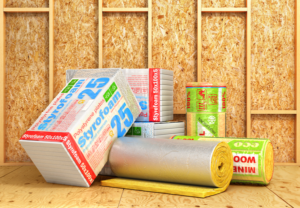 Bare walls with different types of insulation packaged up.