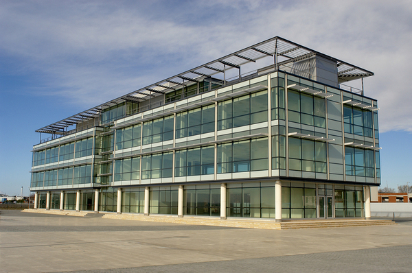 Glass building with blue sky in the background.