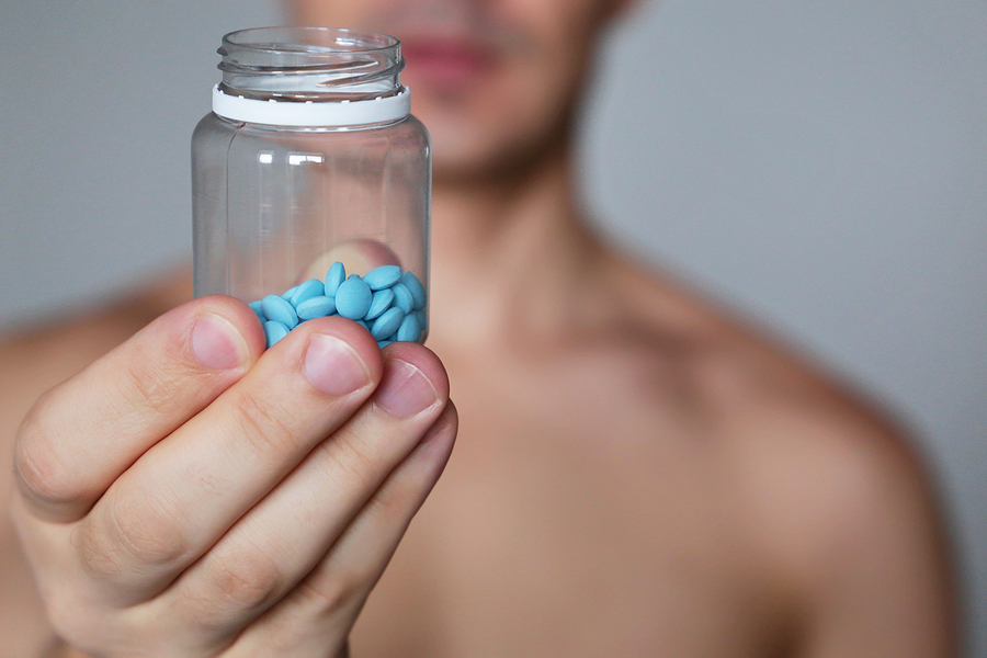 Clear bottle of blue pills.