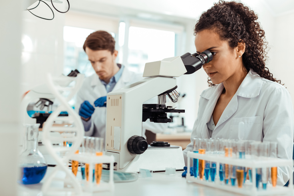 Scientists using microscopes