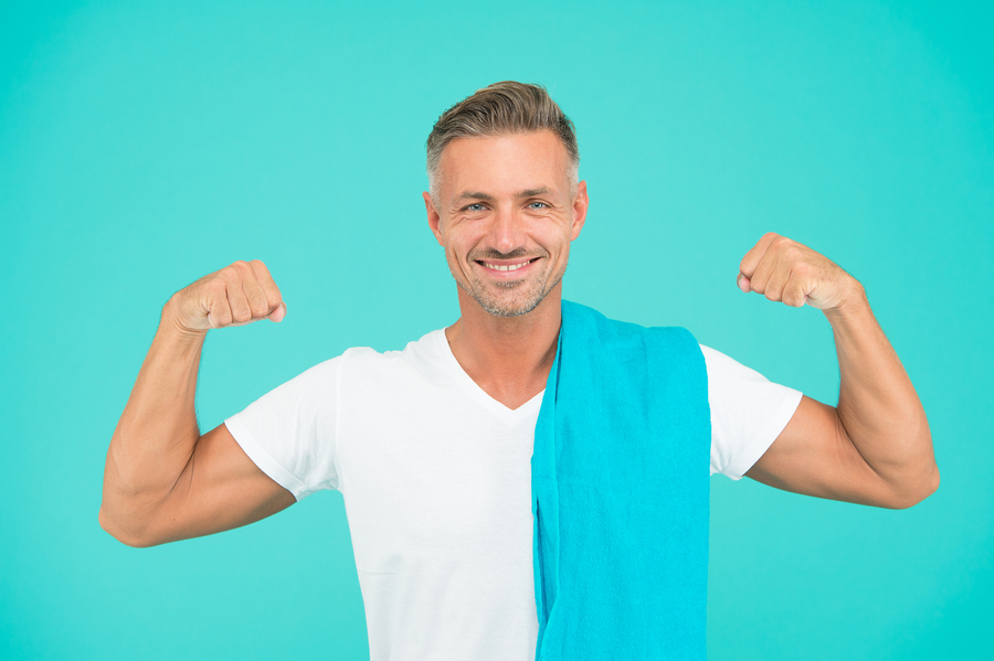 Man raising his arms to show fitness.